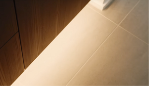 Nordlux LED strip lighting under a wooden cabinet with a YouTube video player overlay.