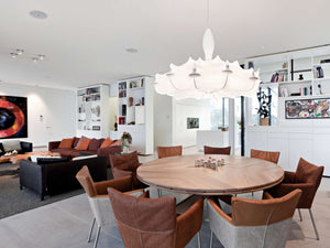 white chandelier over dining table with chairs